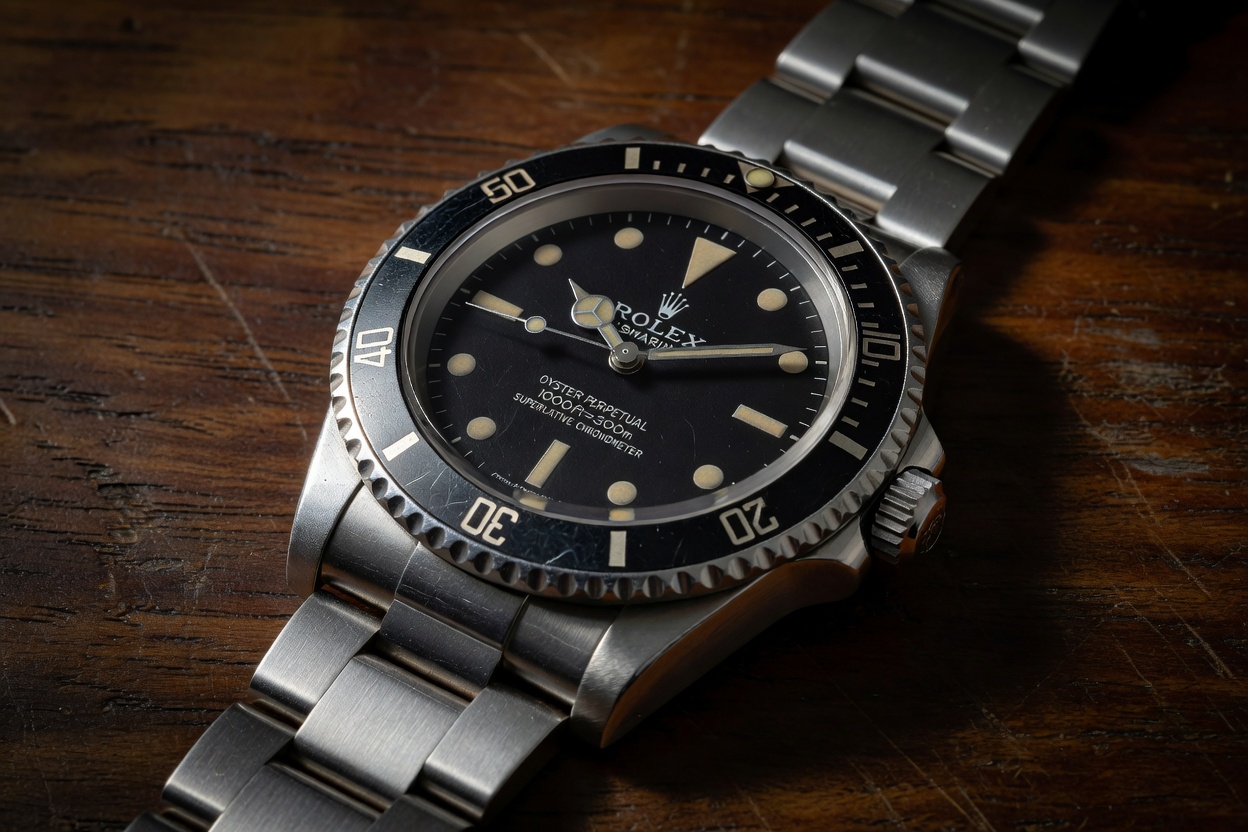 Vintage stainless steel dive watch with black dial representing the Rolex Submariner 5513